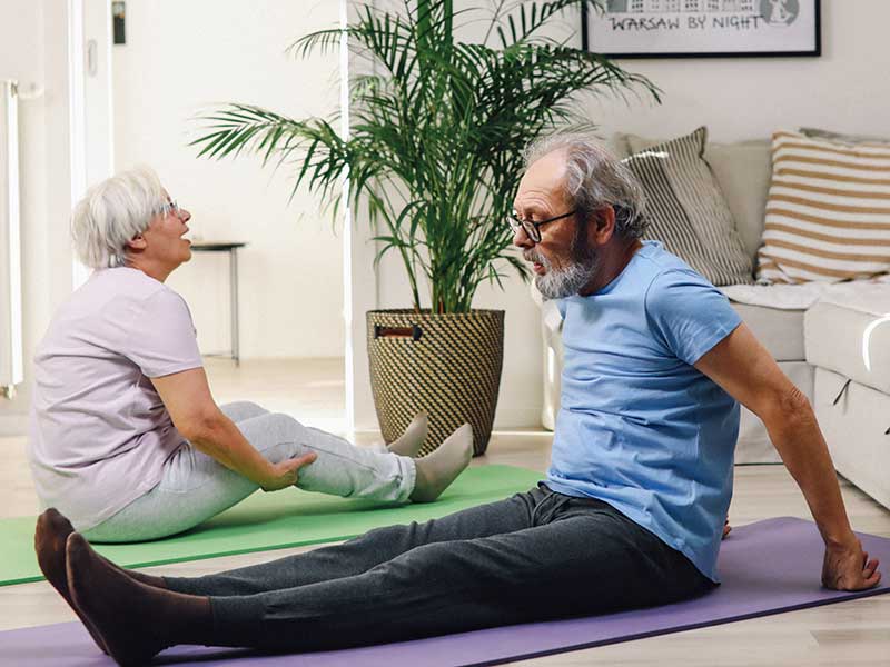 man and woman exercising on yoga mat
